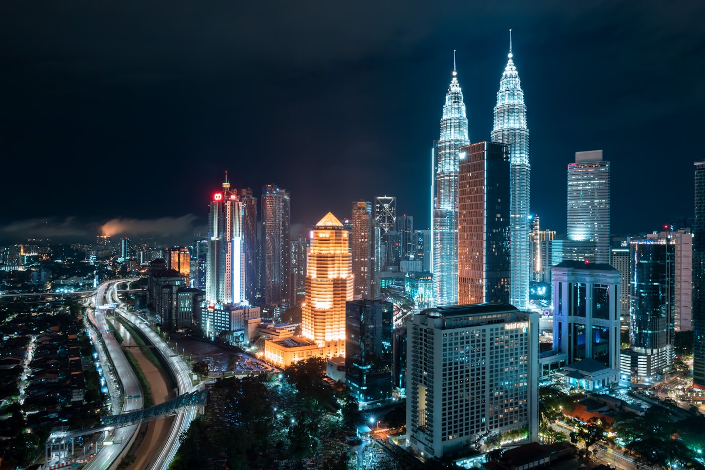 Kuala Lumpur at dusk, the towers lit above the city centre.