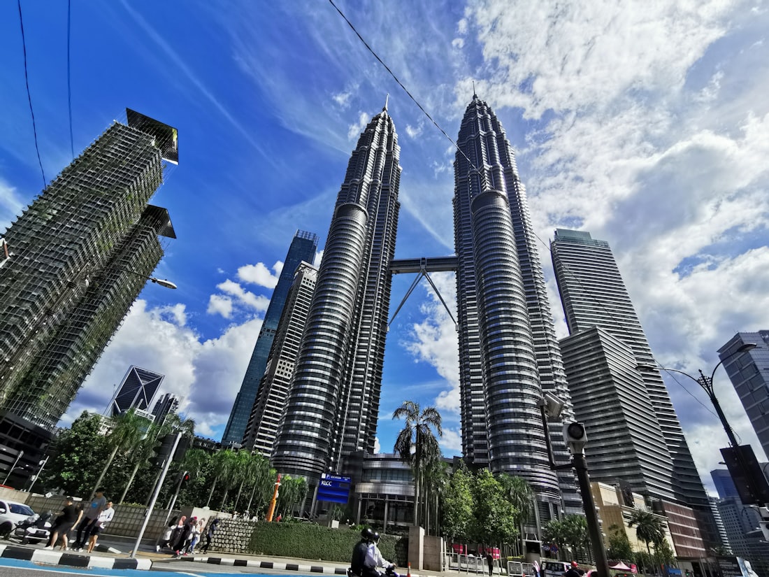 A Kuala Lumpur street below the towers on a working afternoon.