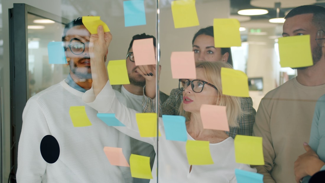 A team planning an increment against a wall of notes.